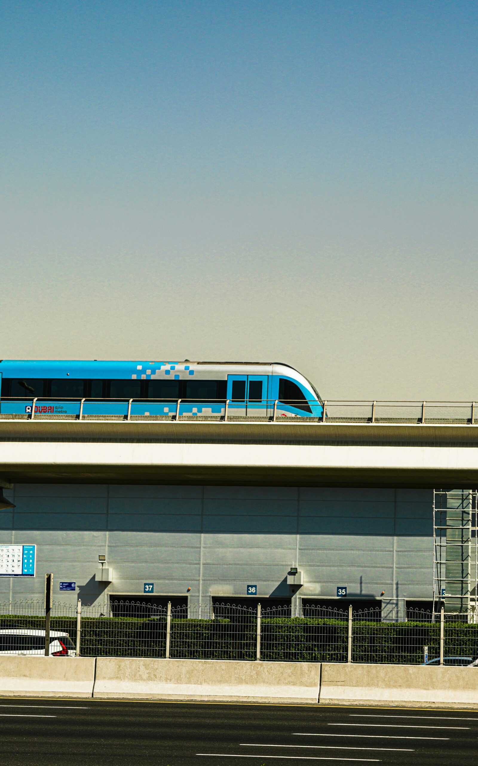 Dubai Metro train passing through the city skyline on an elevated track in Dubai.